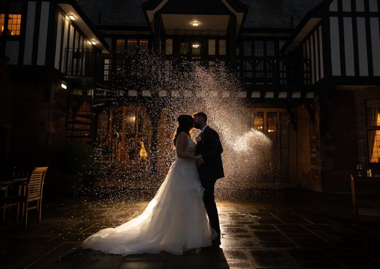 Bride and Groom outside Inglewood Manor Wedding Venue with nigh backdrop