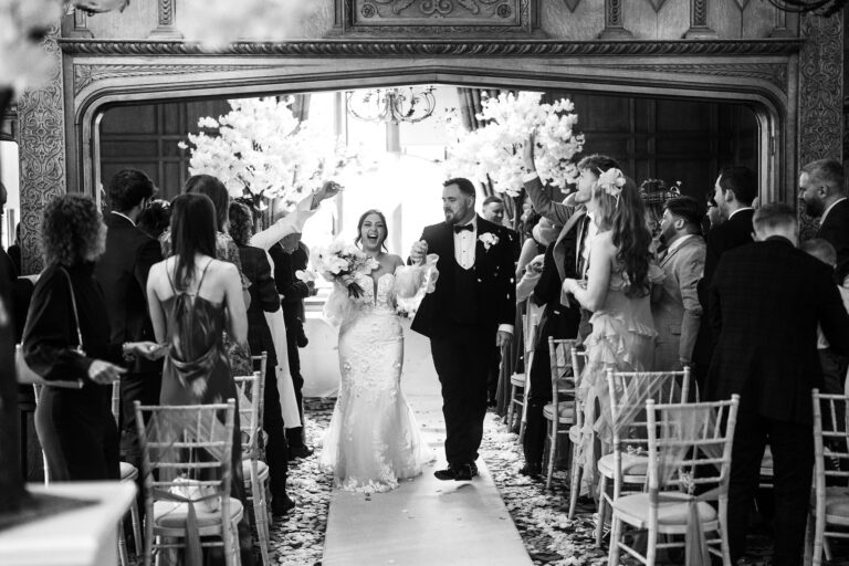 bride & groom walking down the aisle at inglewood manor house