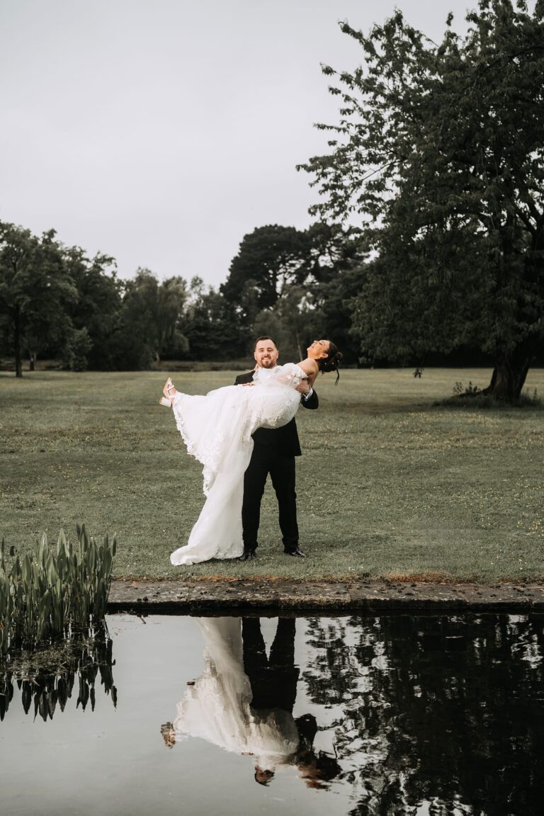 Groom holding bride at inglewood manor house grounds
