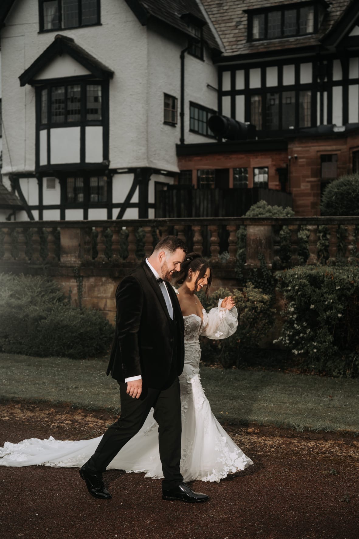 bride and groom walking on the grounds of inglewood manor house wedding venue